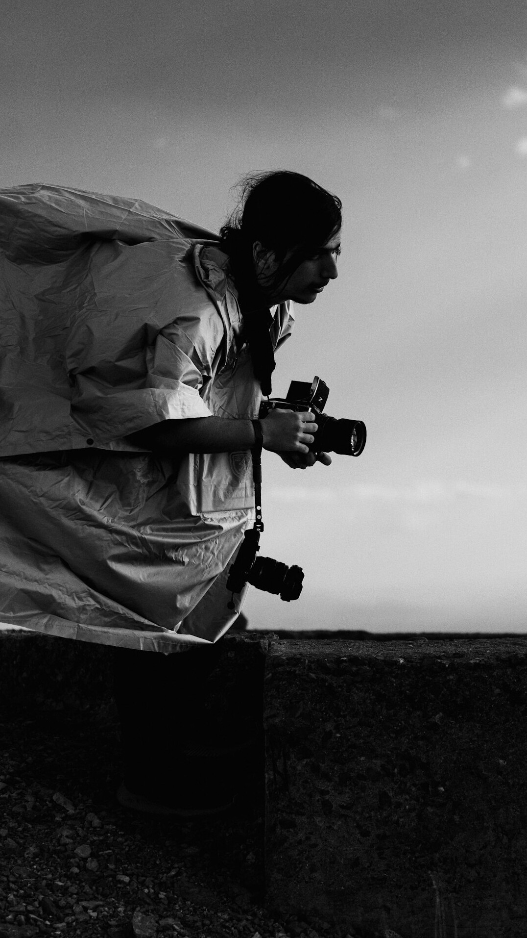 Documentary photographer with camera working outdoors