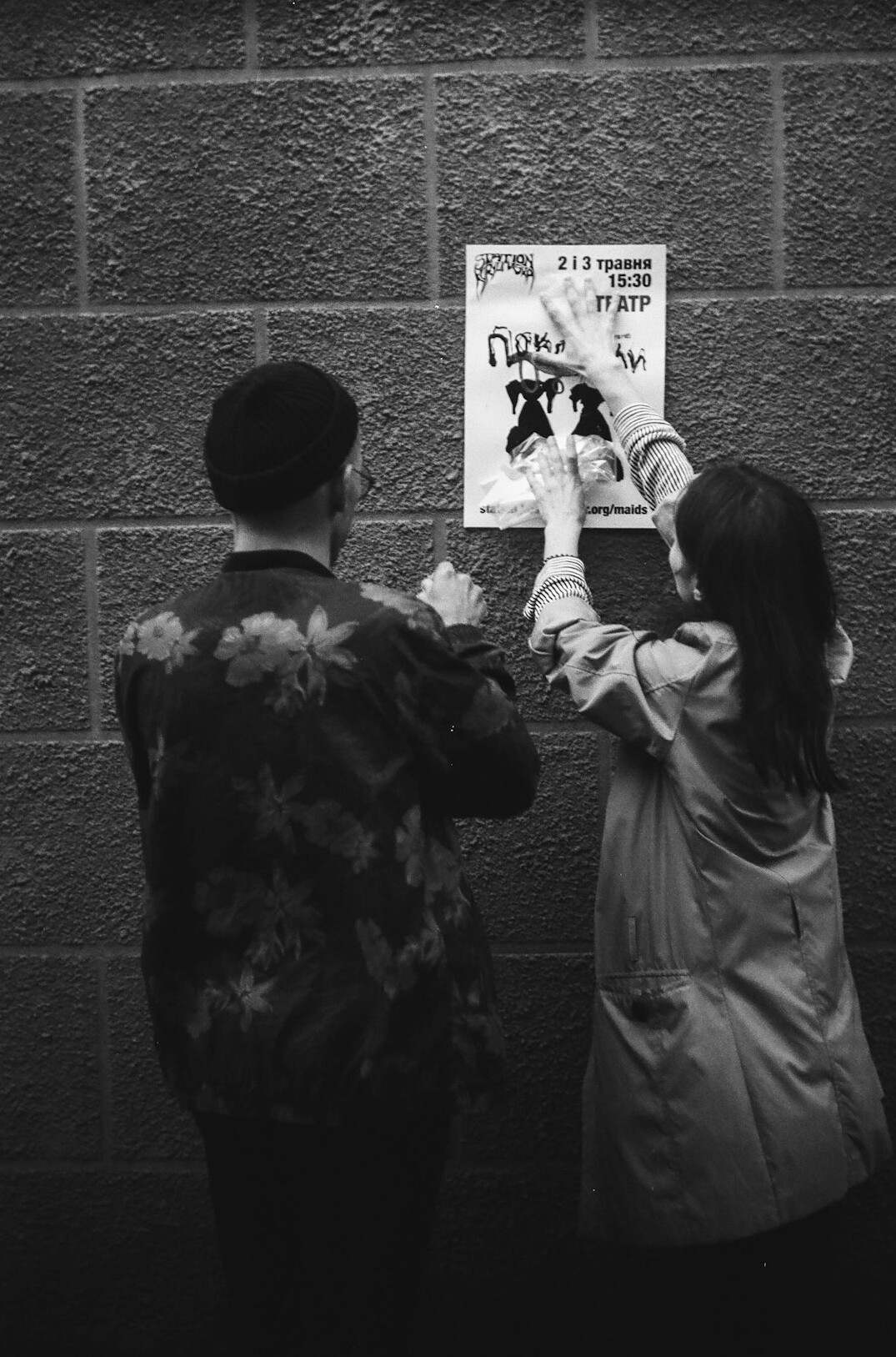 Mentor and student reviewing a narrative structure chart on a wall